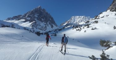 deux personnes en ski face à la montage